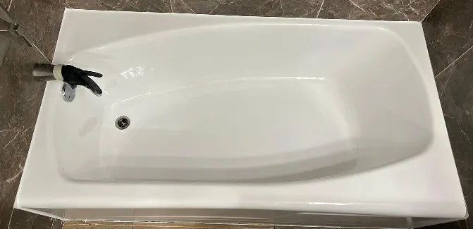 After bathtub reglazing with smooth, glossy, like-new refinished bathtub