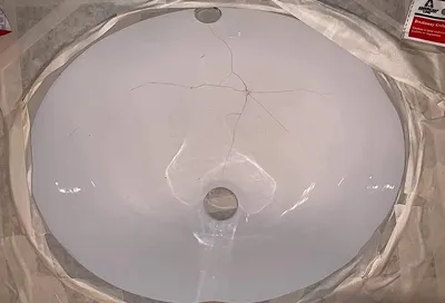 Bathroom sink before reglazing with discoloration and surface damage