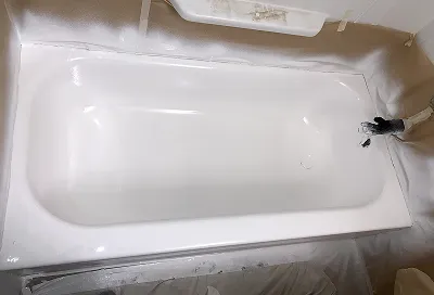 Golden bathtub after reglazing with smooth, glossy, like-new finish