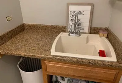 Damaged sink basin before reglazing with visible wear and stains