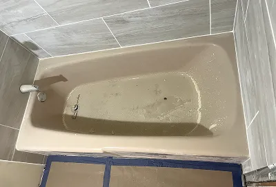 Old bathtub before reglazing with chipped and discolored finish