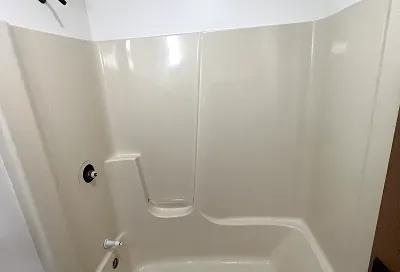 Tile before reglazing showing stains, discoloration, and worn grout