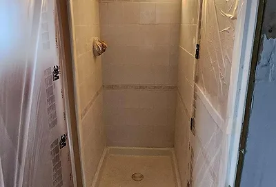 Tile walls before reglazing with cracked and dirty grout lines