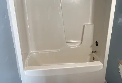 Worn shower stall walls before restoration and reglazing process