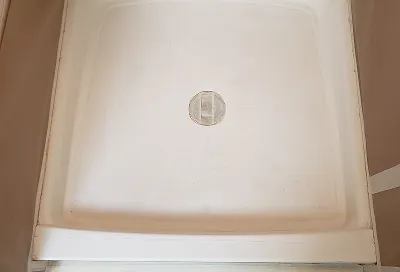 Shower stall after reglazing with smooth, glossy, like-new finish