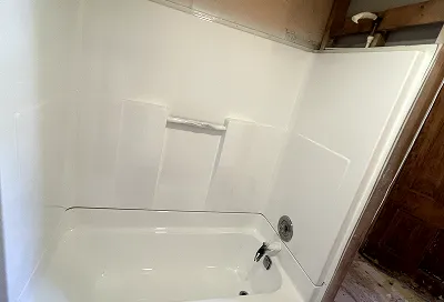 Restored fiberglass shower stall after reglazing looking like new