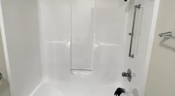 Professional refinishing of a platform drop-in bathtub